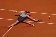 Mirra Andreeva stretching to retrieve a ball at the French Open 2024 (Getty Images)